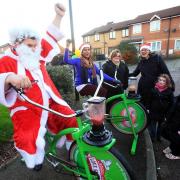 Father Christmas hops on a smoothie-making bicycle during Saturday's fair