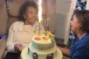 Gwendolyn and her niece  Beverley Chung, who made the cake, which features edible photos on top and around the cake depicting different decades in Gwendolyn's life from age 16