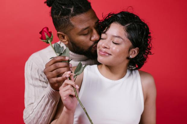 Enfield Independent: A man giving his partner a red rose. Credit: Canva