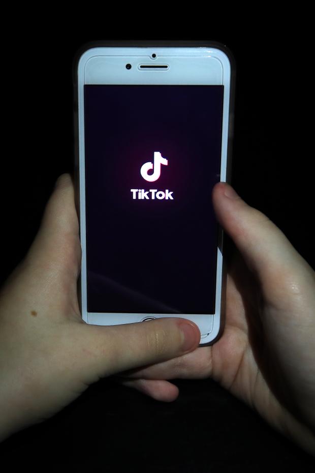 Enfield Independent: A person with TikTok open on their phone. Credit: PA