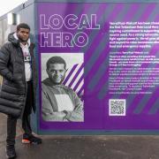Verral Paul-Walcott with his Tottenham Hale Local Hero tribute on the hoarding on the North Island site at Tottenham Hale