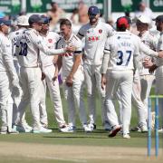 Jamie Porter celebrates one of his six wickets with Essex teammates