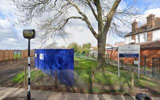 Travellers set up camp near an entrance of Winchmore School
